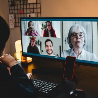 Multi generational business woman having video call with colleagues using computer app